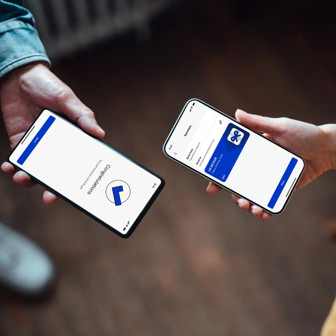 Two people holding smartphones facing each other, displaying the PaysafeCard app..